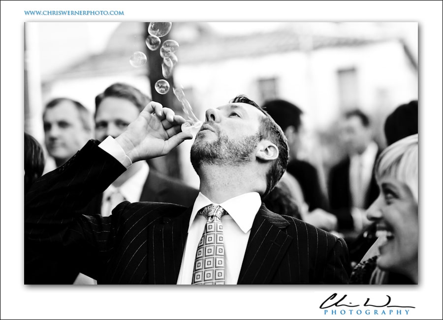 Groomsman blowing bubbles after the wedding, Presidio Wedding Photography.