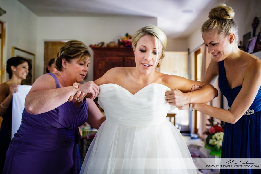 Bride puts on her wedding dress before her Culinary Institute of America Wedding.