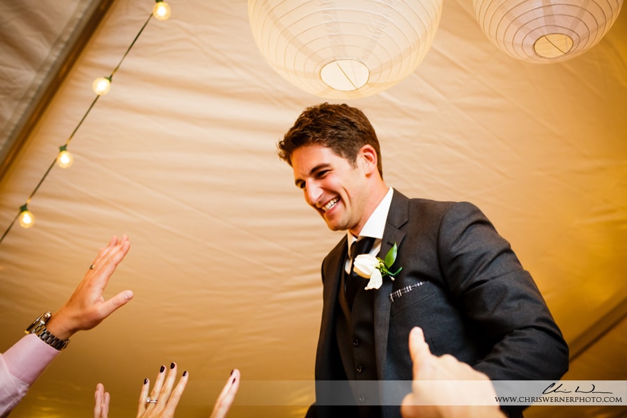 Wedding guests carrying the groom on the dance floor, by wedding Photographers Lake Tahoe.