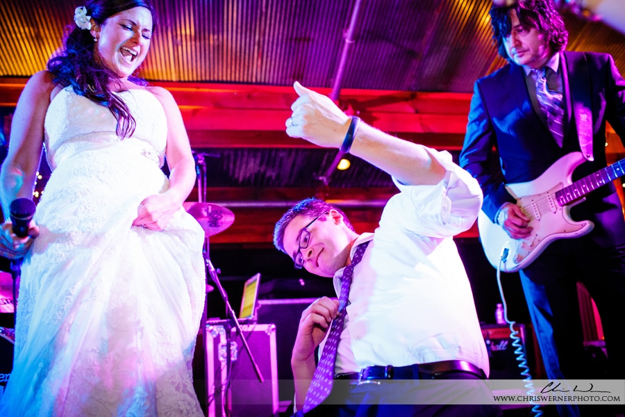 Photos of the groom playing air guitar with the Raleigh wedding band.