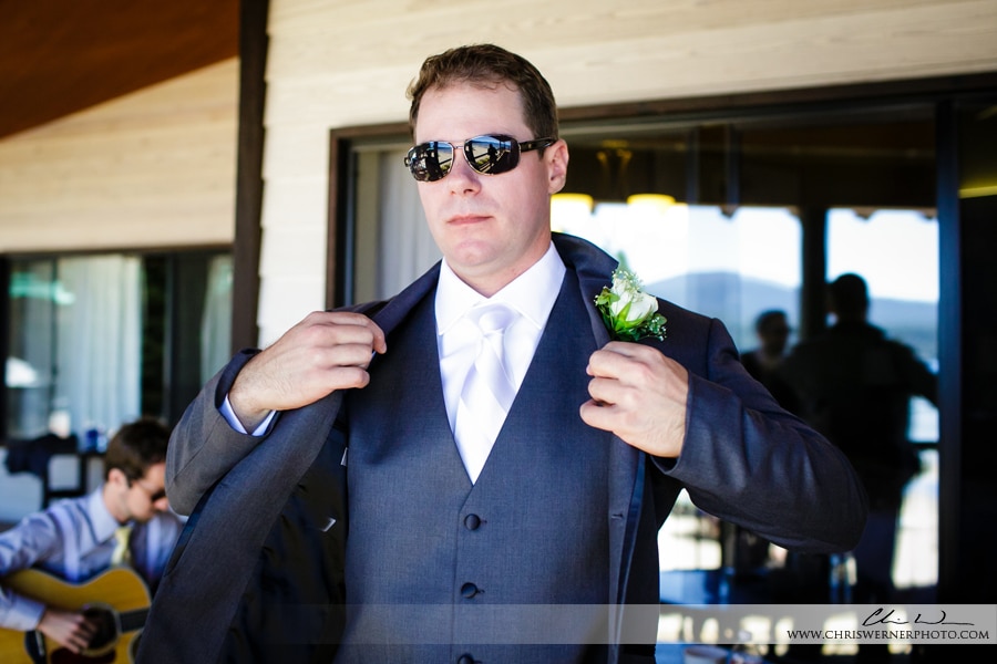 Groom putting on his suit before the wedding, by Mourelatos Lake Tahoe Wedding Photographers.