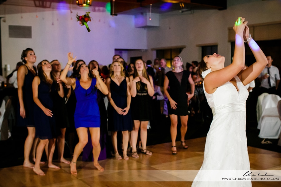 Photo of the bride throwing the bouquet at the end of a Squaw Valley PlumpJack wedding. 