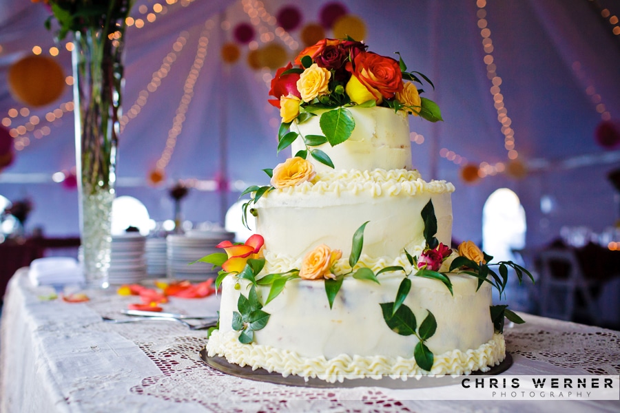 Wedding cake with orange roses.