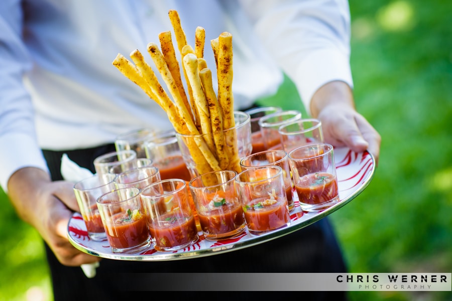 Tomato bisque wedding appetizer with breadsticks.