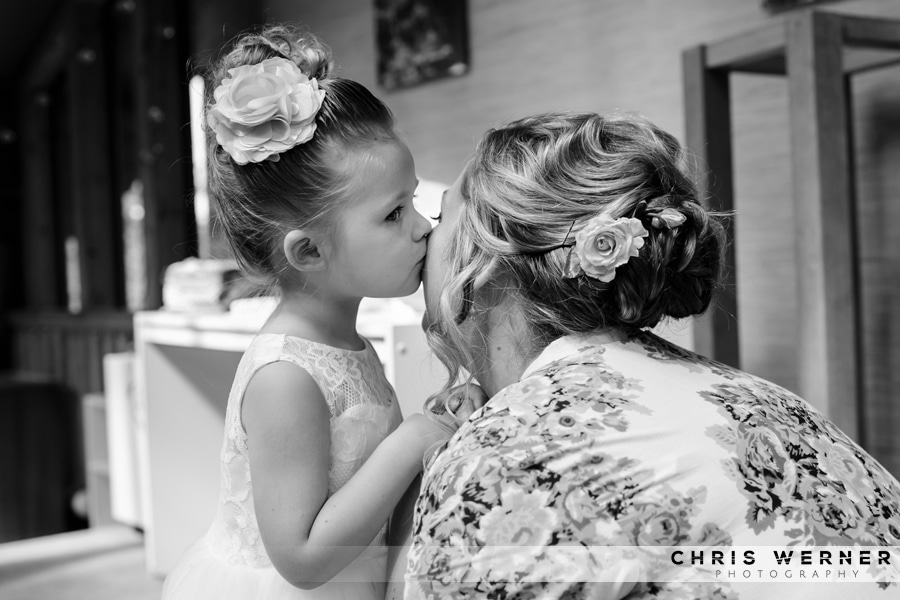 Flower girl kissing the bride before her Lake Tahoe Tree Company wedding.