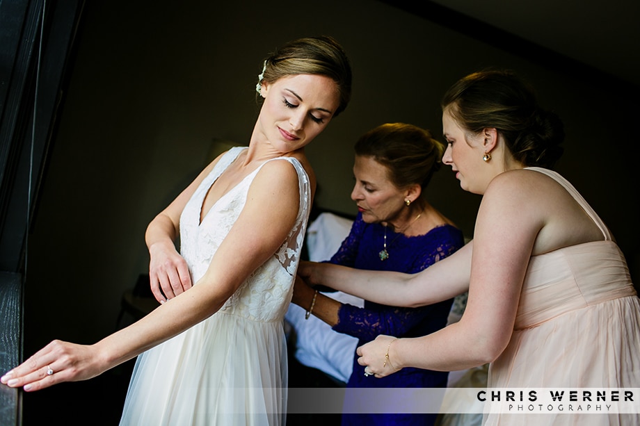 Zipping up the bride's dress: Squaw Valley PlumpJack weddings.