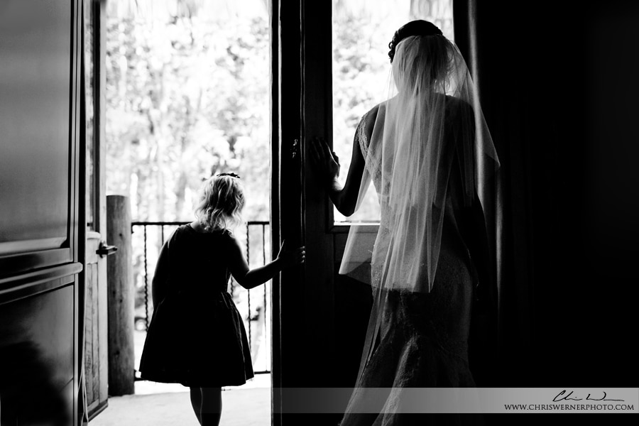 Photo of a bride and flower girl looking out the window, T Lazy 7 Ranch Wedding.