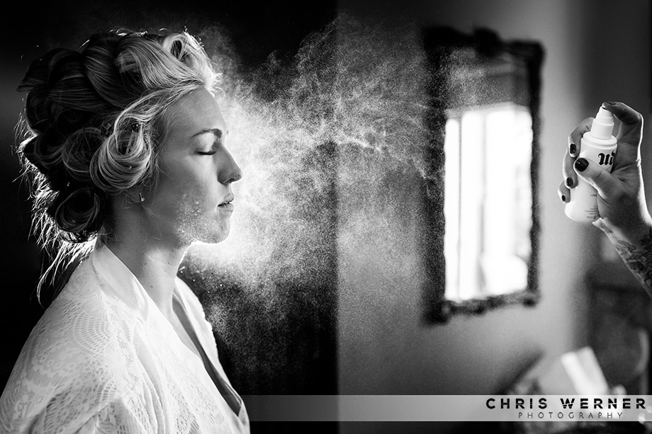 Artistic photo of a bride getting hairspray, by a Reno wedding photographer