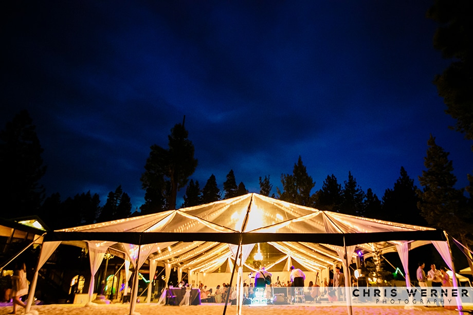 Photo of a Lake Tahoe beach wedding tent at dusk.