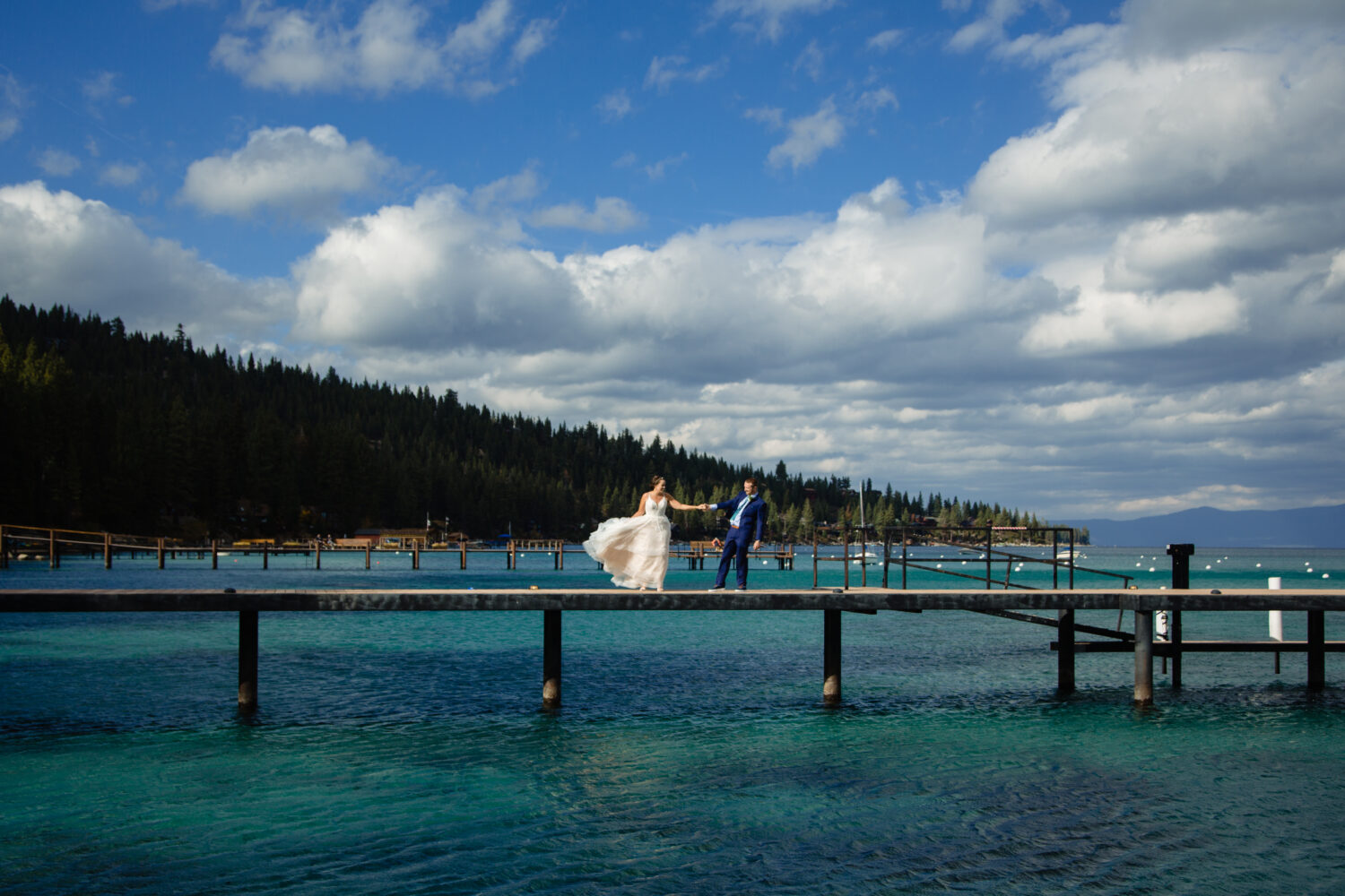 A couple that decided to have a micro wedding in Lake Tahoe enjoy the views from a private dock.