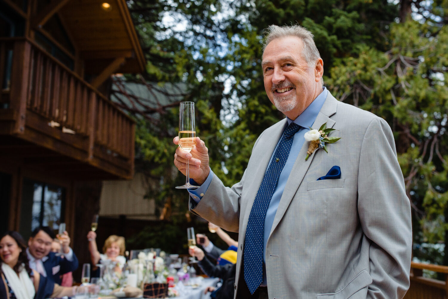 The father of the bride gives a champagne toast at a backyard wedding in Tahoe.