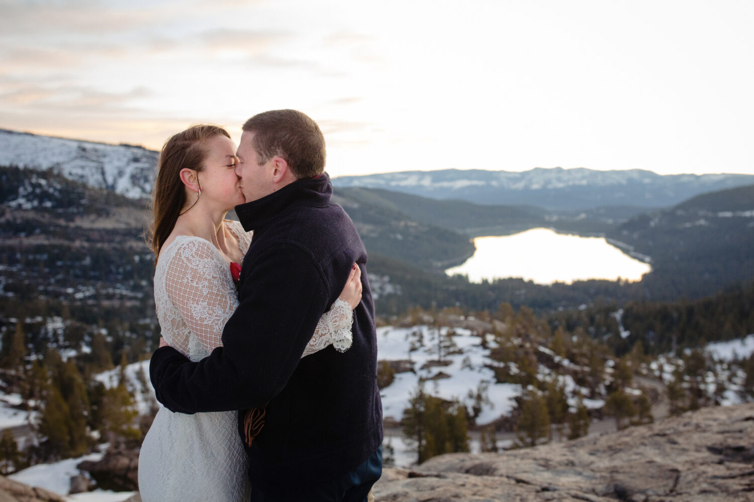 Eloping on a mountain in Lake Tahoe during winter with snow in the background.