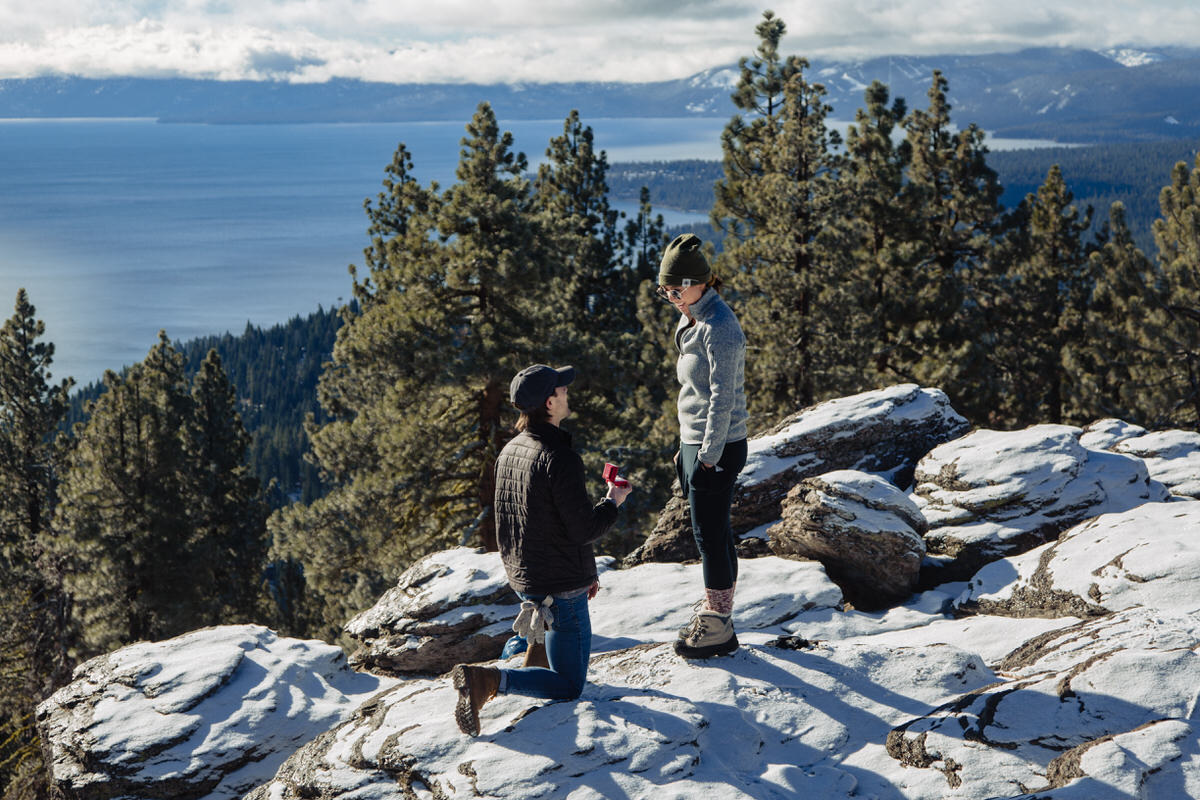 Getting down on one knee for a surprise proposal atop a snowy mountain in Lake Tahoe.