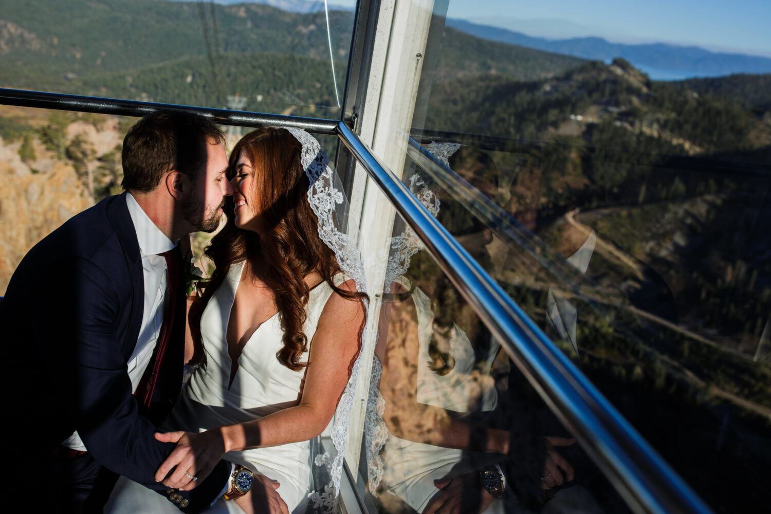 A bride and groom share a panoramic view and a romantic moment during the tram ride to their High Camp Palisades wedding.