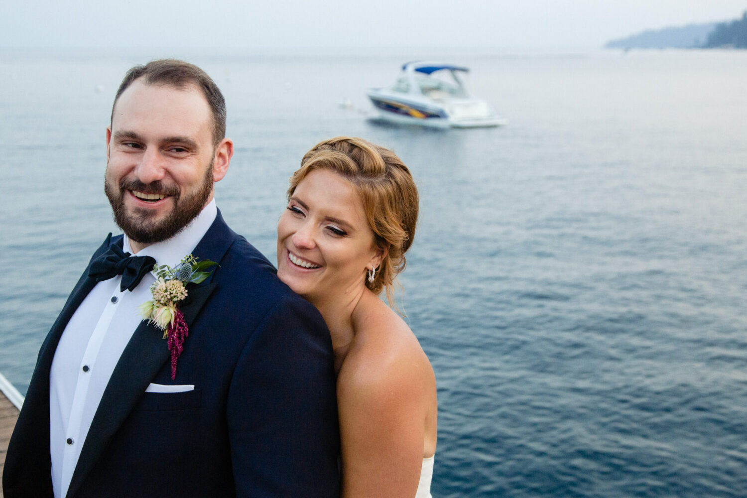 A couple that decided to get married at Gar Woods enjoys a moment together on the pier.