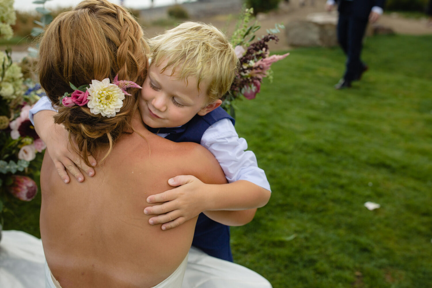 Big hugs for the bride from a boy ring bearer.