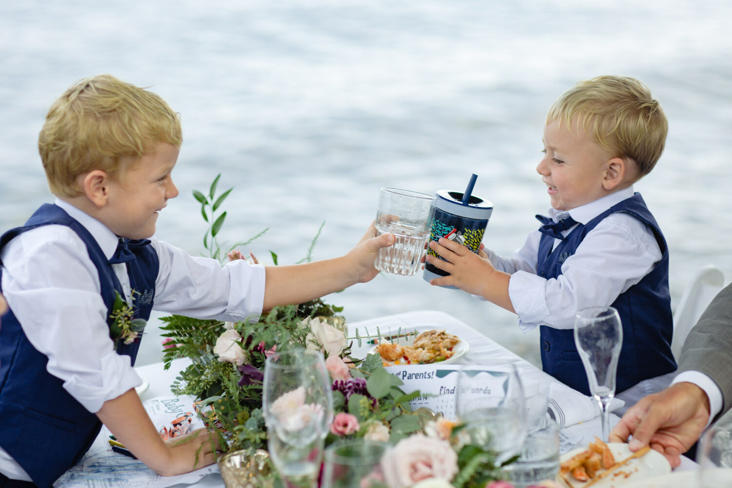 Two boy ring bearers celebrate during a champagne toast.