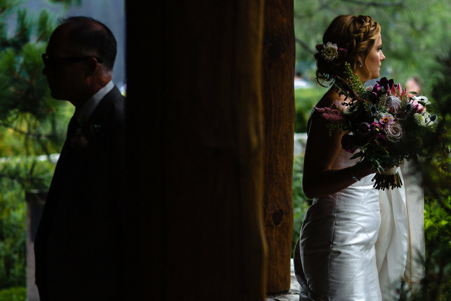 A bride holds her floral bouquet as she waits for the wedding to start.