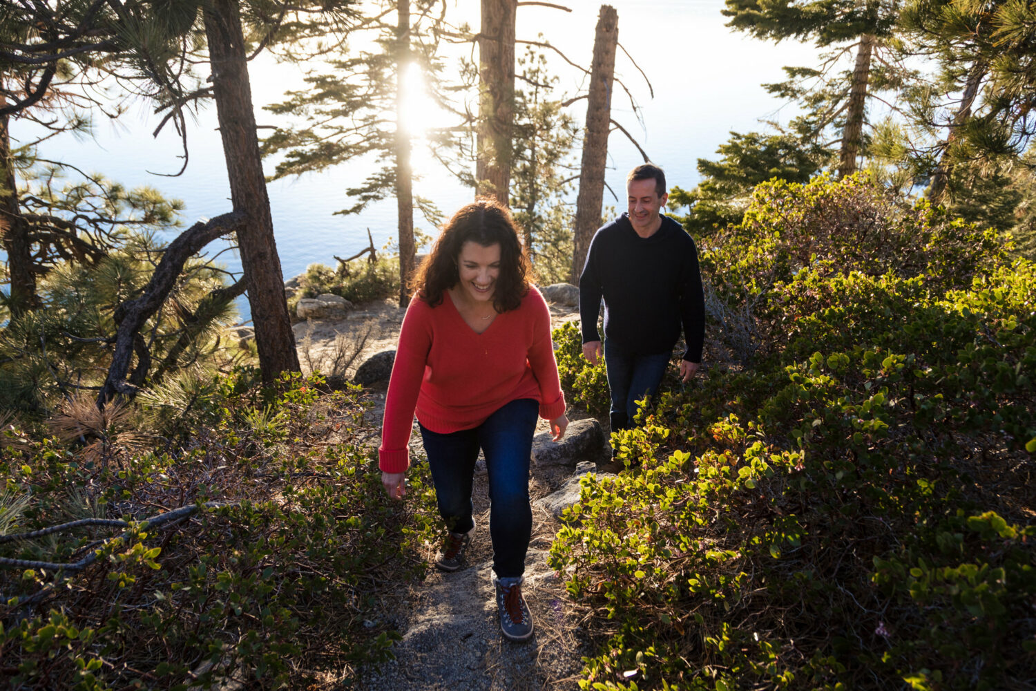 Hiking on a trail during an engagement portrait session next to Lake Tahoe.