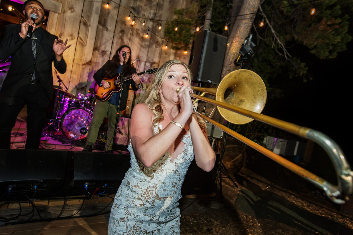 A bride borrows a trombone from a Lake Tahoe wedding band.