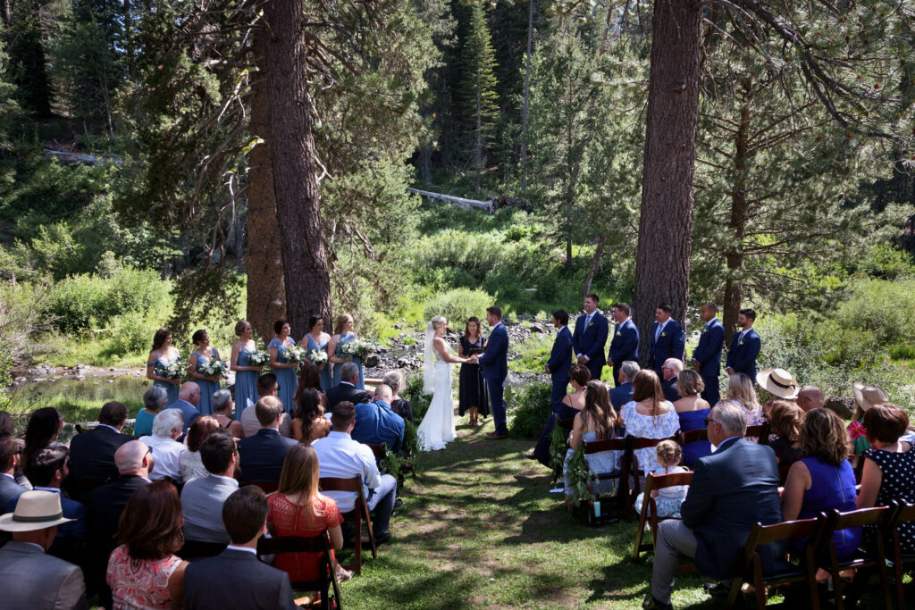 A wide-angle view of the wedding ceremony site by the river.