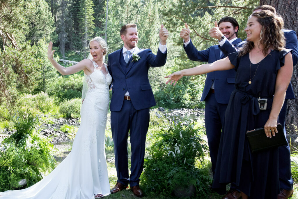 Bride and groom celebrate with the officiant and groomsmen after their wedding ceremony. 