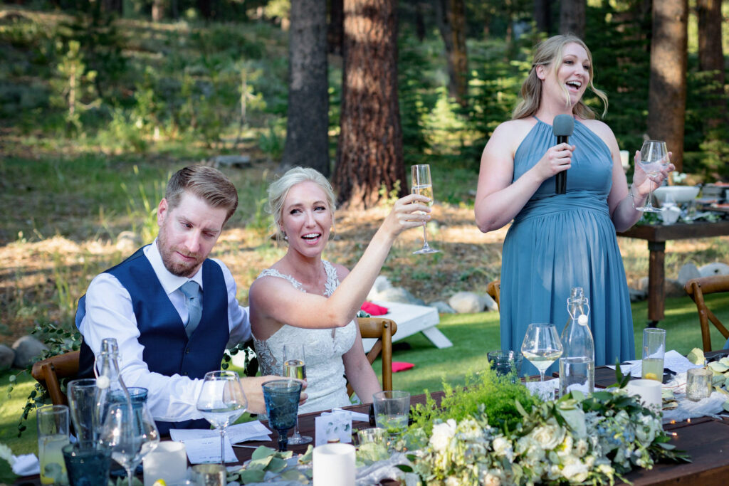 The bride and groom react to the maid of honor's humorous wedding reception speech at Dancing Pines Resort.