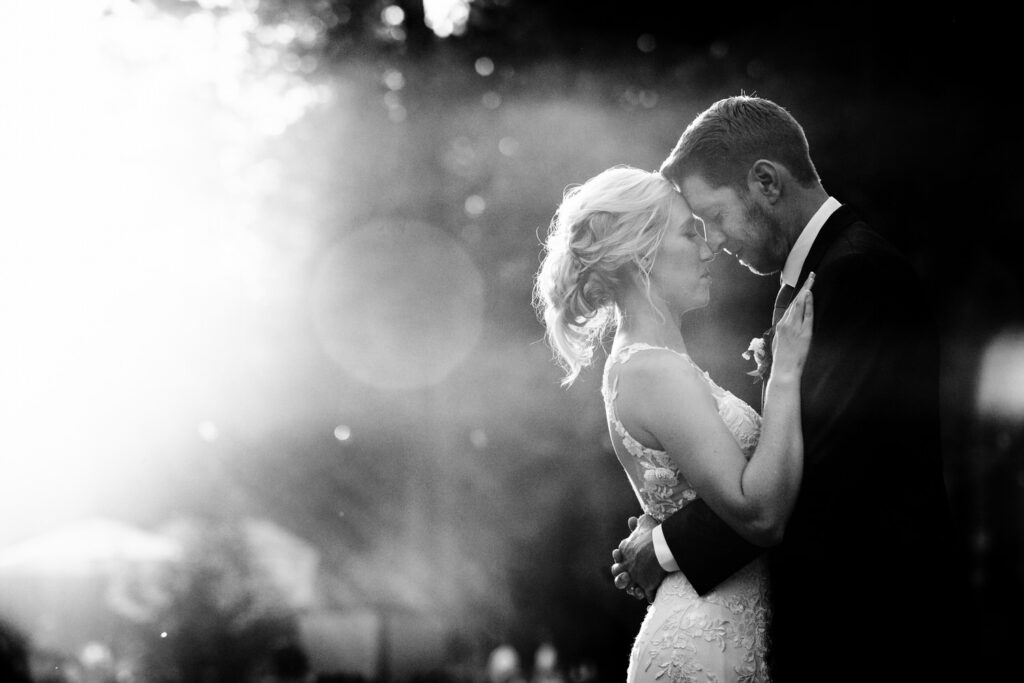 Bride and groom embrace during their wedding portraits at Dancing Pines.