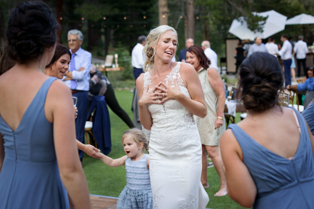 A bride enjoys the dance floor with her bridesmaids at a Dancing Pines wedding near Truckee, CA.