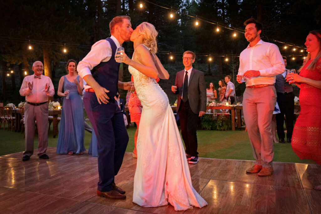 The bride and groom lean in for a nighttime kiss on the dance floor at Dancing Pines Resort near Truckee, CA. 