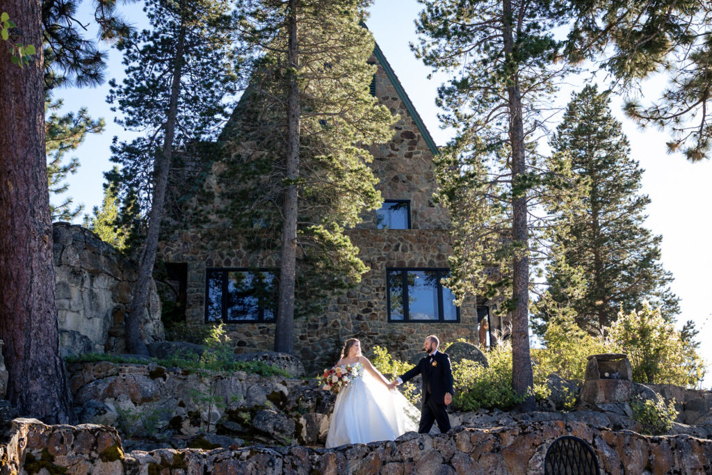 Bride and groom walk in front of the mansion at Thunderbird Lodge, Lake Tahoe, NV.