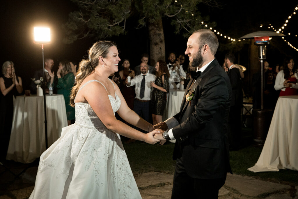 Surrounded by friends, the bride and groom dance the night away at their Lake Tahoe wedding.