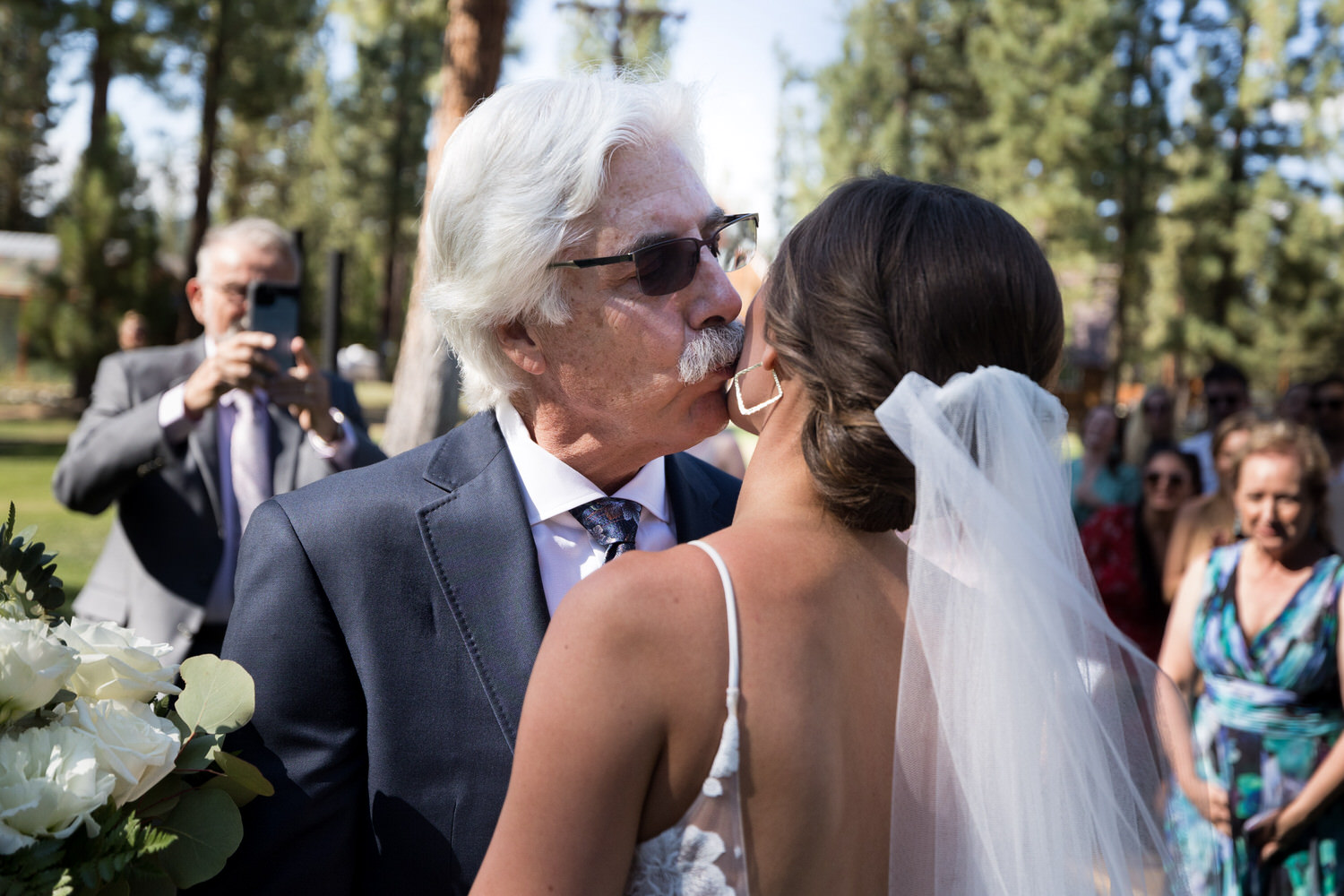A candid moment between the bride and her dad, captured by wedding photographer Chris Werner.