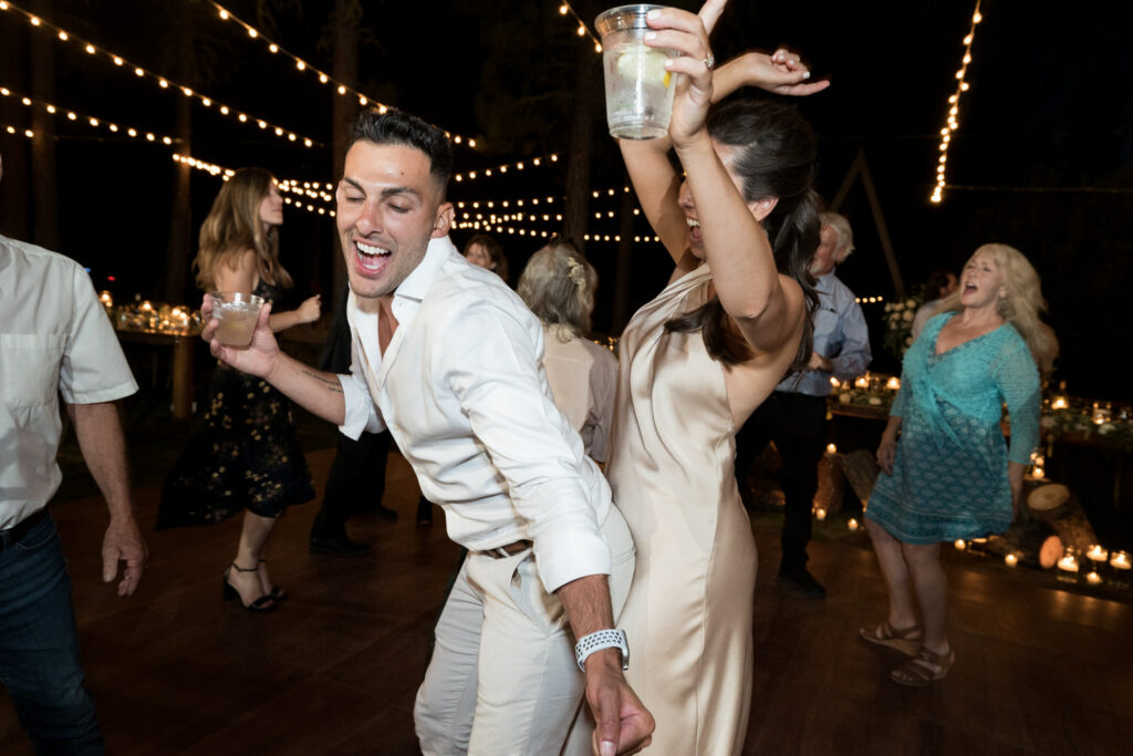 Wedding guests party and dance together at a Chalet View Lodge wedding reception in the Sierra Nevada mountains.