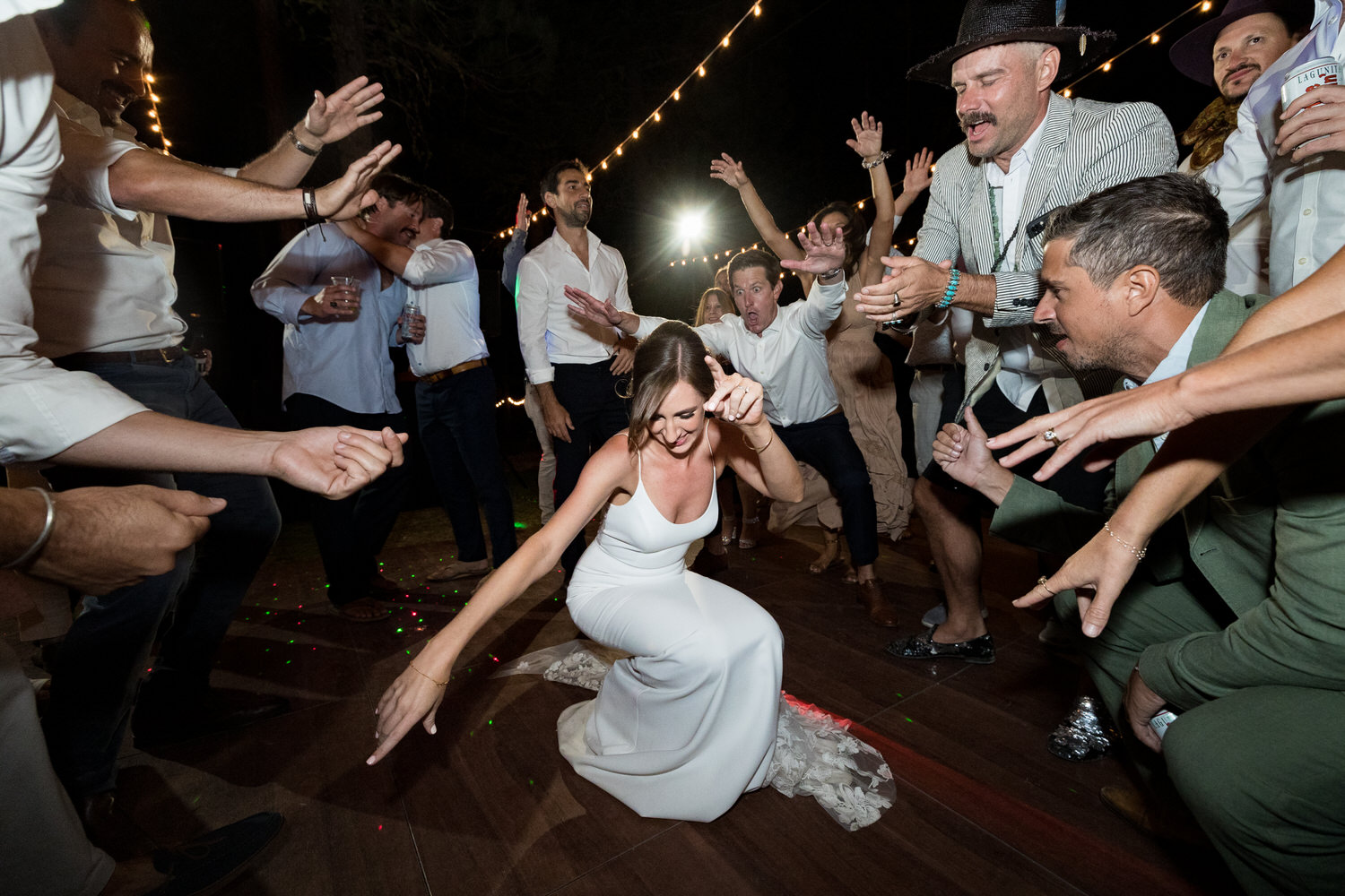 Shimmying low and close to the floor, wedding guests dance and get their groove on during a reception party in Graeagle, California.