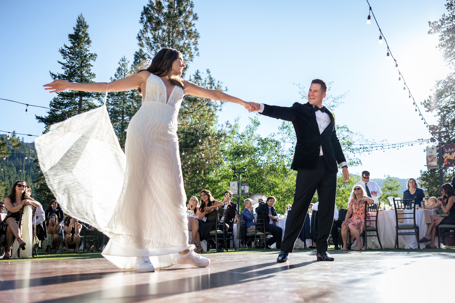 A choreographed wedding dance on an outdoor dance floor at The Pavilion reception area.