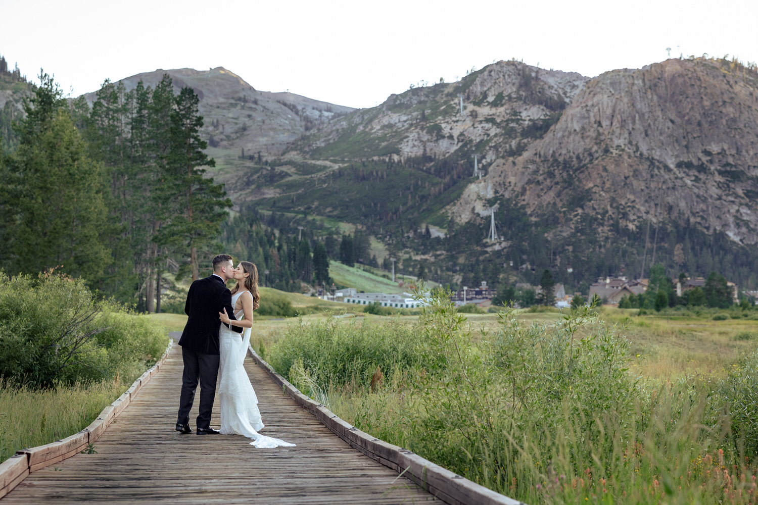 The bride and groom share a kiss at a  sunset photo location in Olympic Valley.
