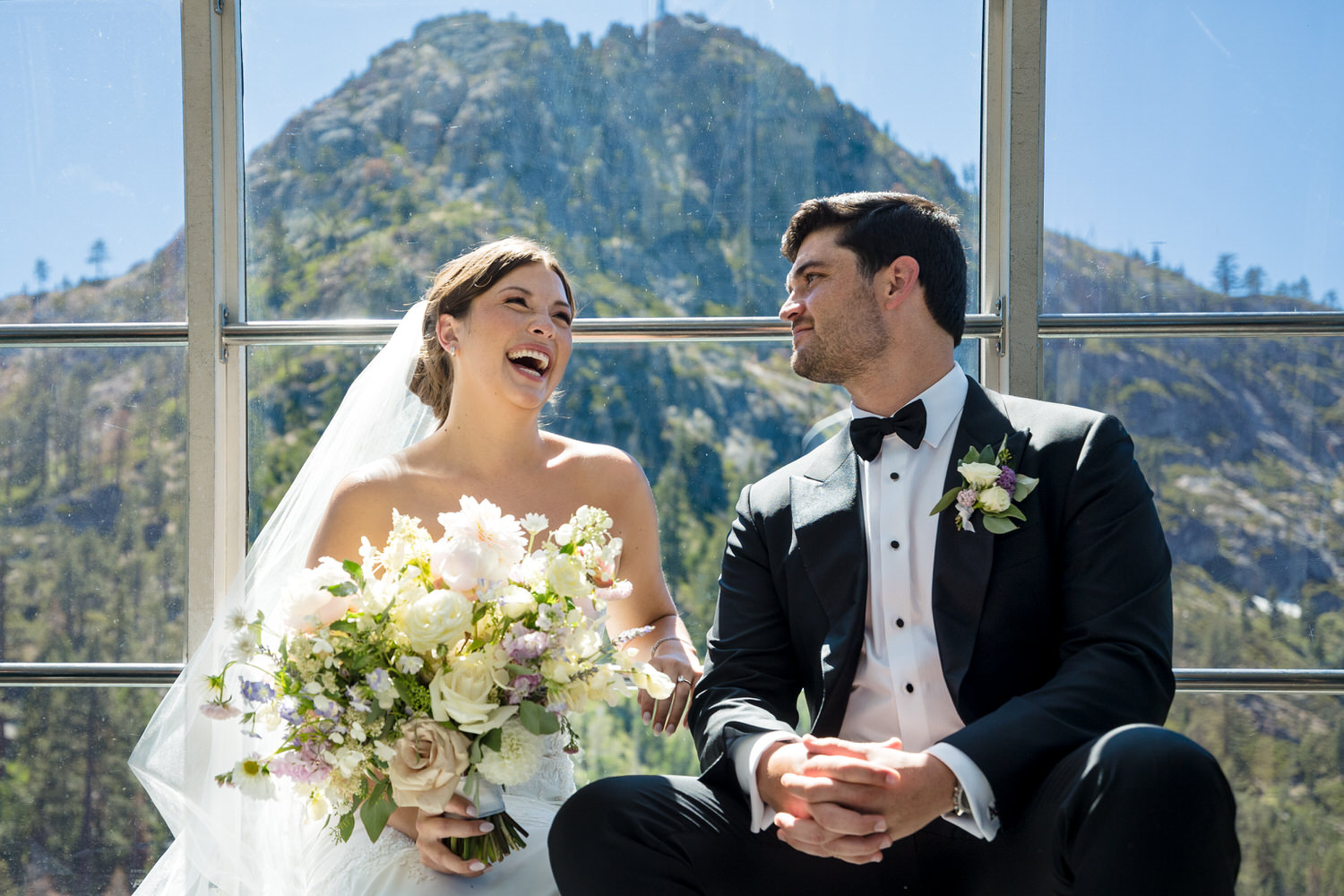 A candid moment between the bride and groom while riding the Palisades Tahoe Aerial Tram to their wedding.