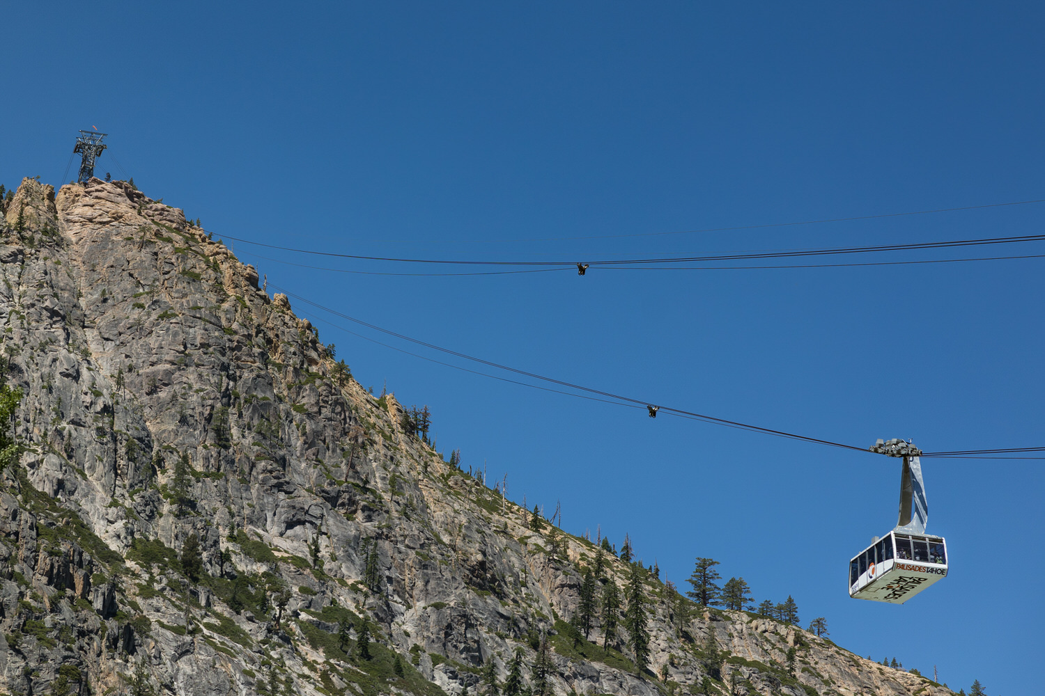 Wedding guests ride in an aerial tram to reach the High Camp ceremony venue.