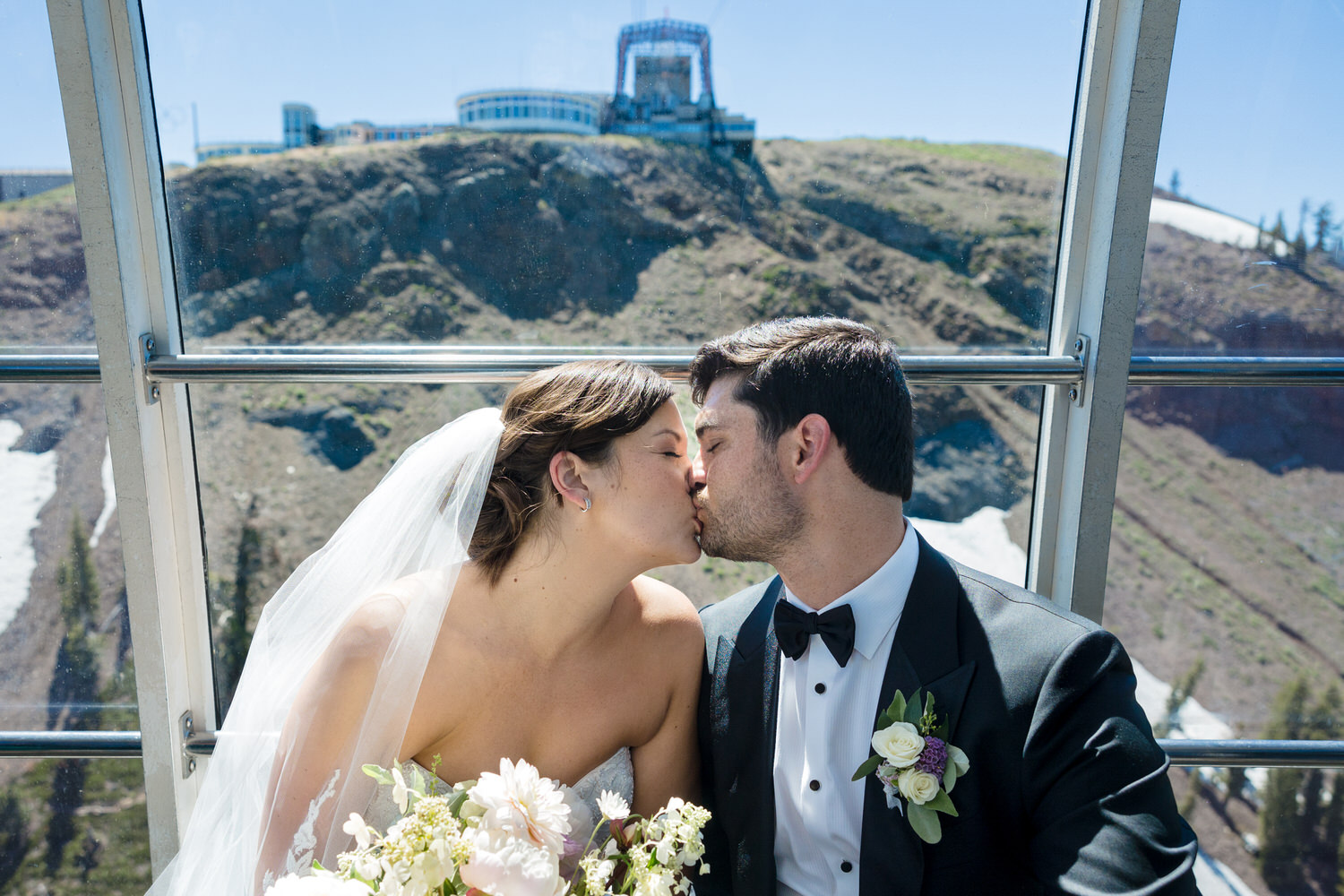 A magical kiss between the bride and groom aboard the aerial tram en route to their High Camp wedding.