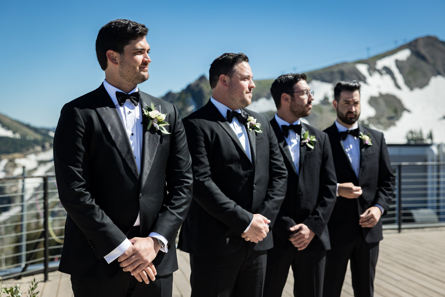 A groom and his groomsmen wait for the bride on the High Camp deck.