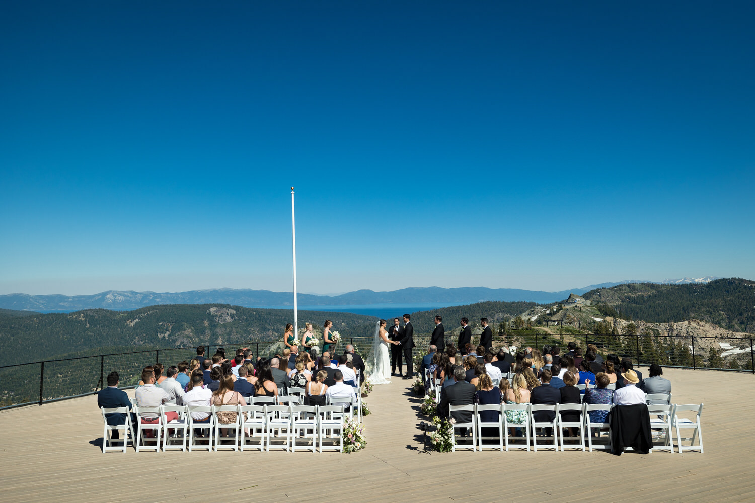 A wide angle view of a High Camp wedding ceremony at Palisades Tahoe.