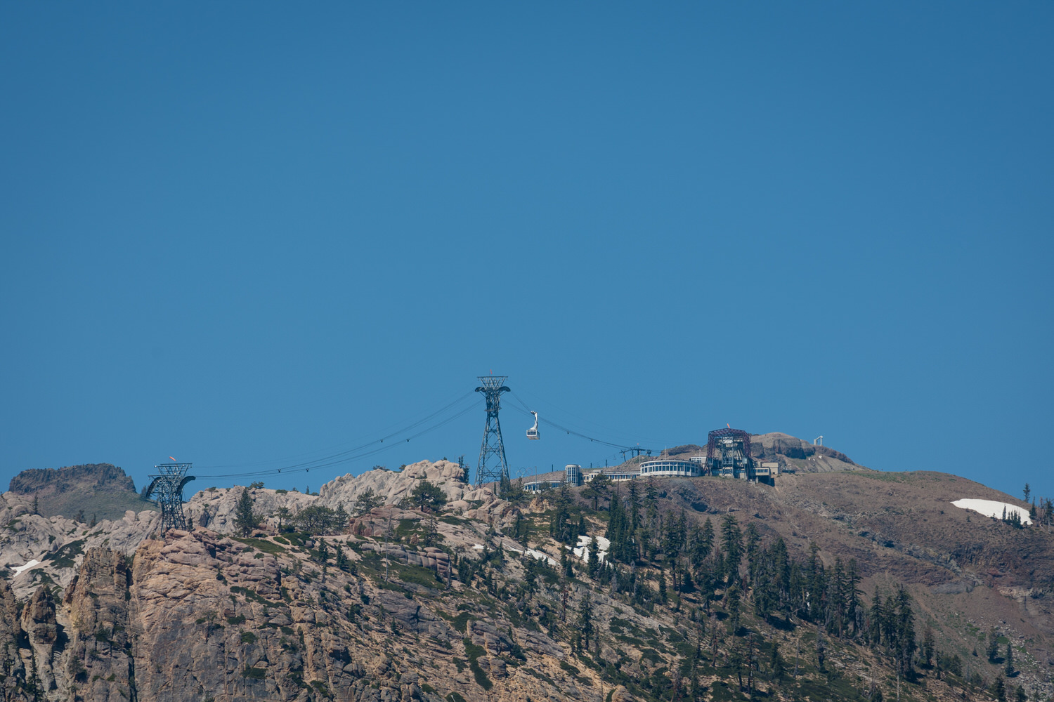 A telephoto view of High Camp at Palisades Tahoe and the aerial tram that transports wedding guests up the mountain.