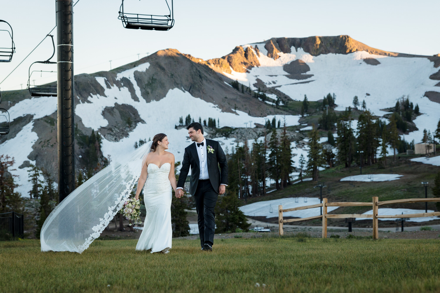 A bride and groom that decided to get married at High Camp take a sunset walk with the Palisades in the background.