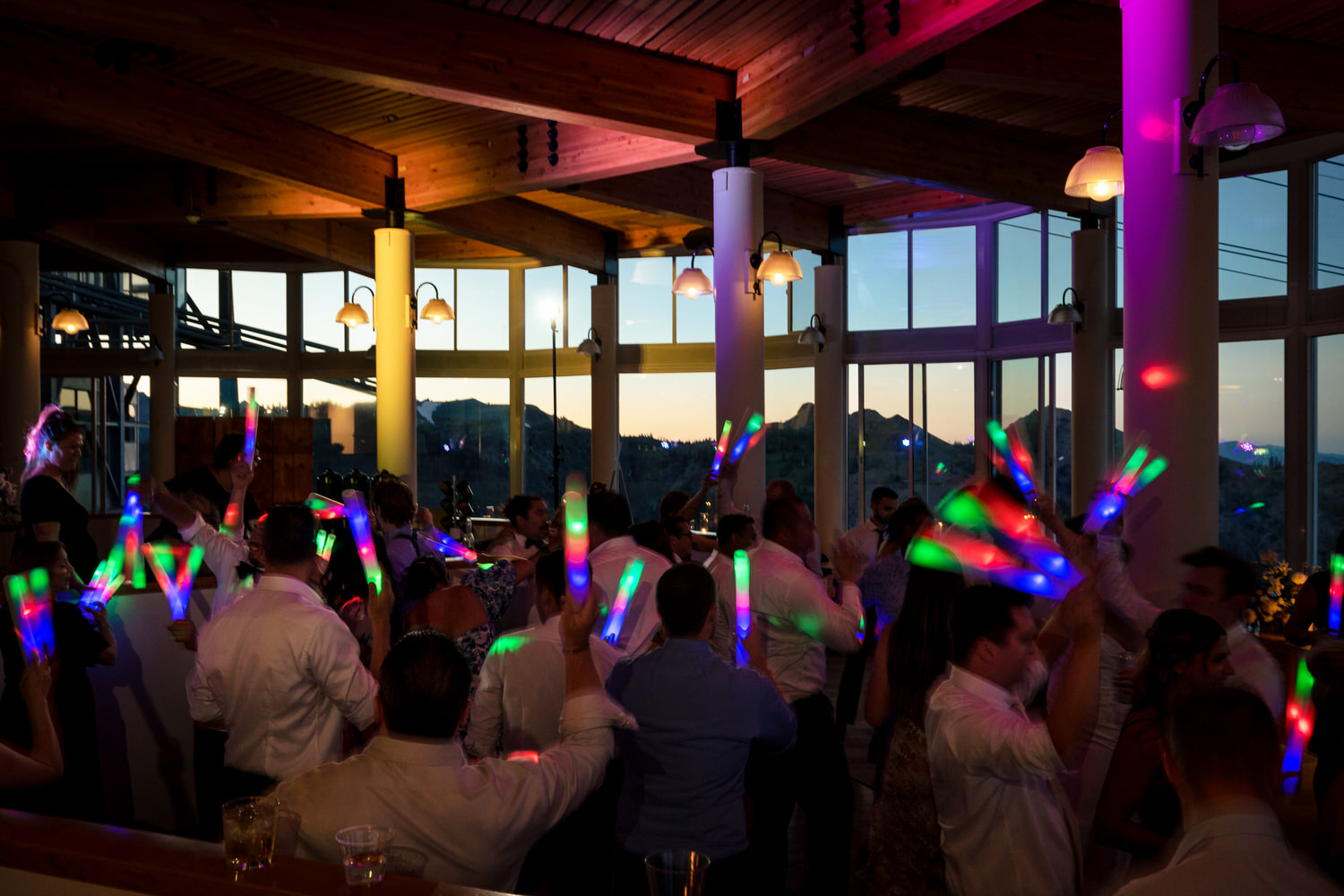 LED foam party sticks and colorful uplighting at a High Camp wedding in Olympic Valley.