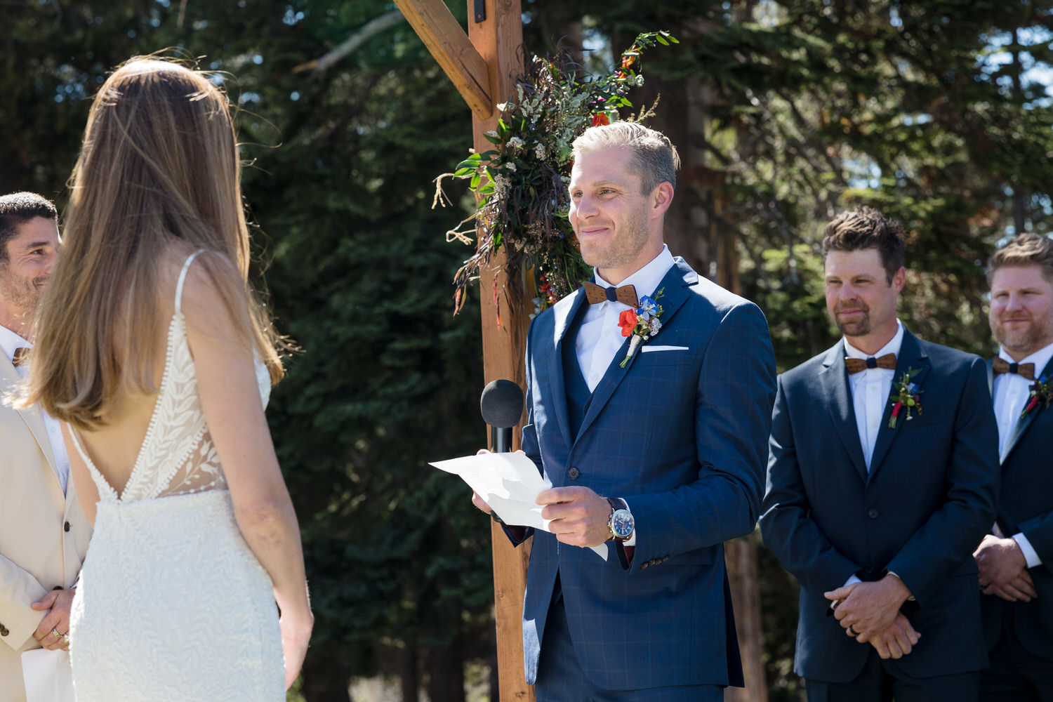 A sincere moment as the groom reads hand-written vows during the ceremony.