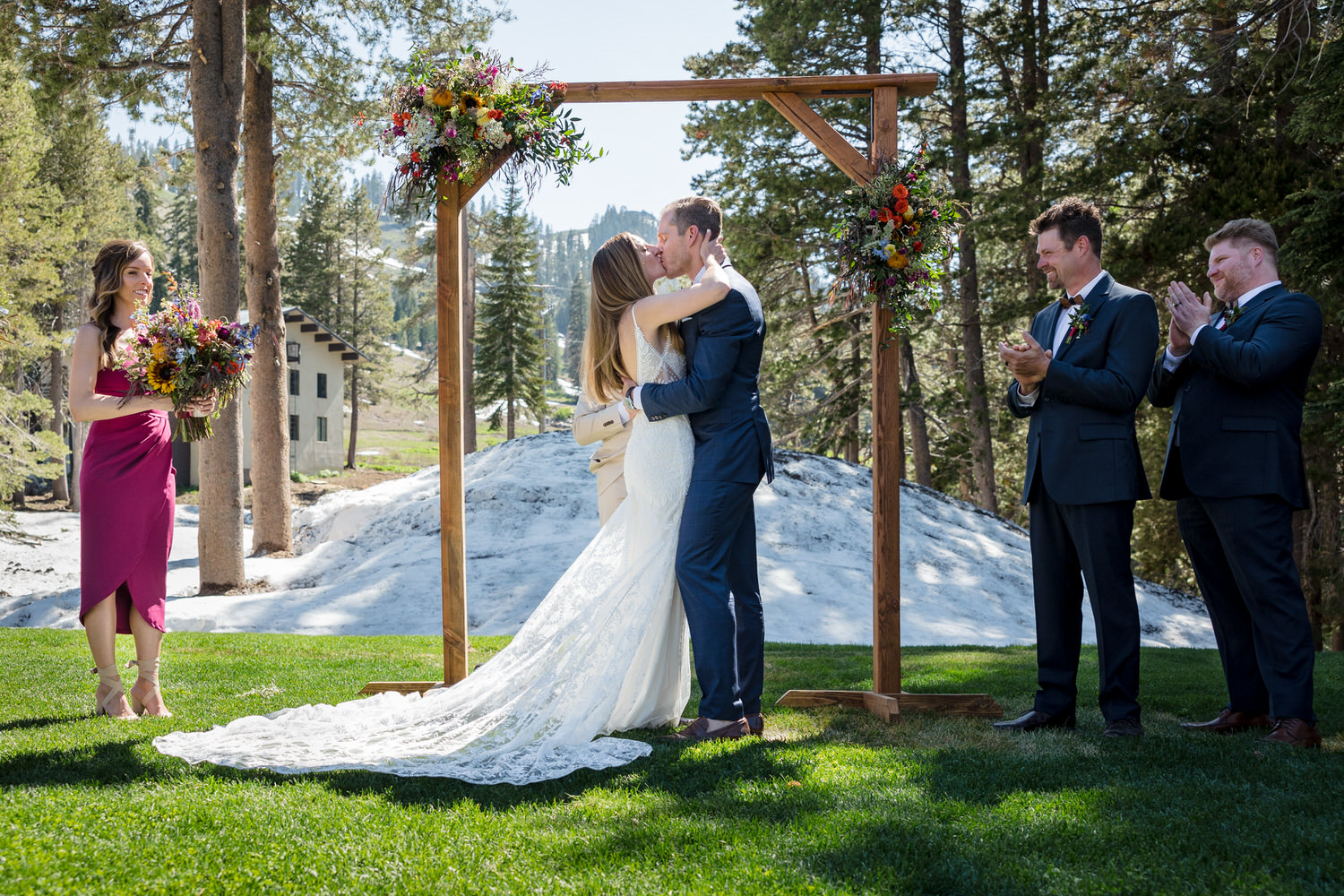 A celebratory first kiss for the bride and groom at a Sugar Bowl Resort ceremony on the lawn.
