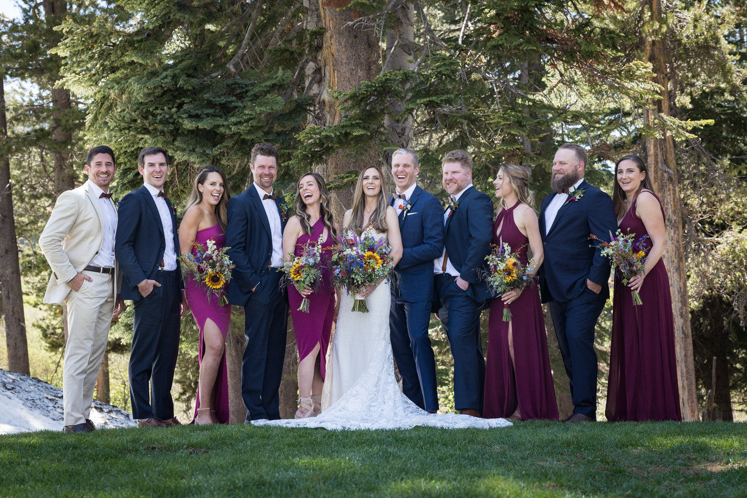 The wedding party laughs spontaneously at a Sugar Bowl Resort group portrait location.