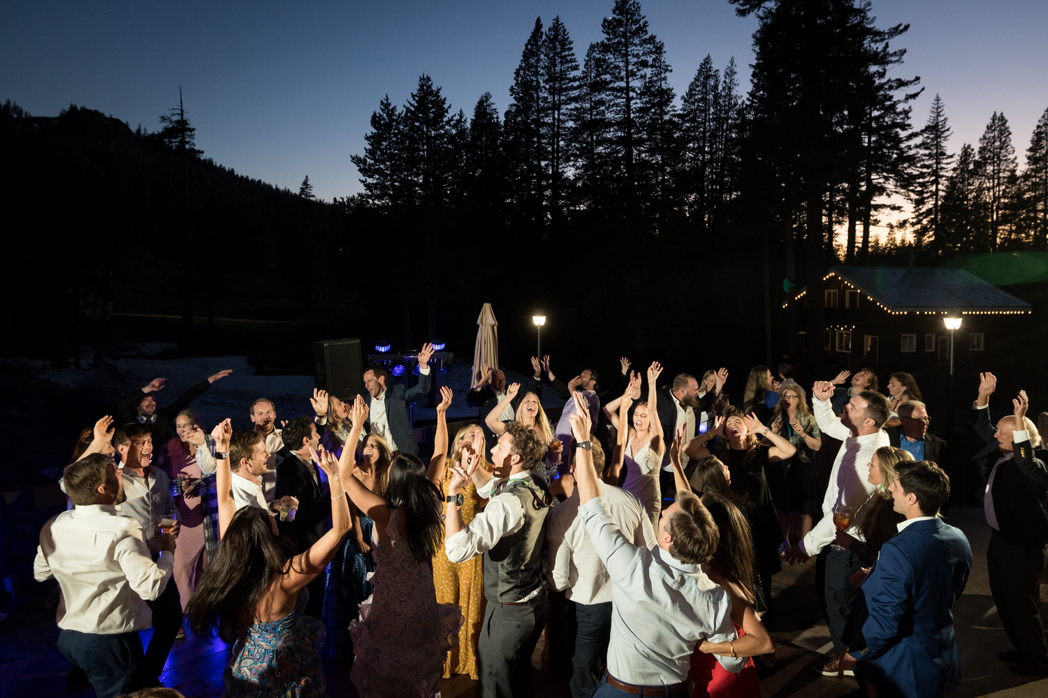 Wedding reception dance party at twilight on the open-air deck at Sugar Bowl.