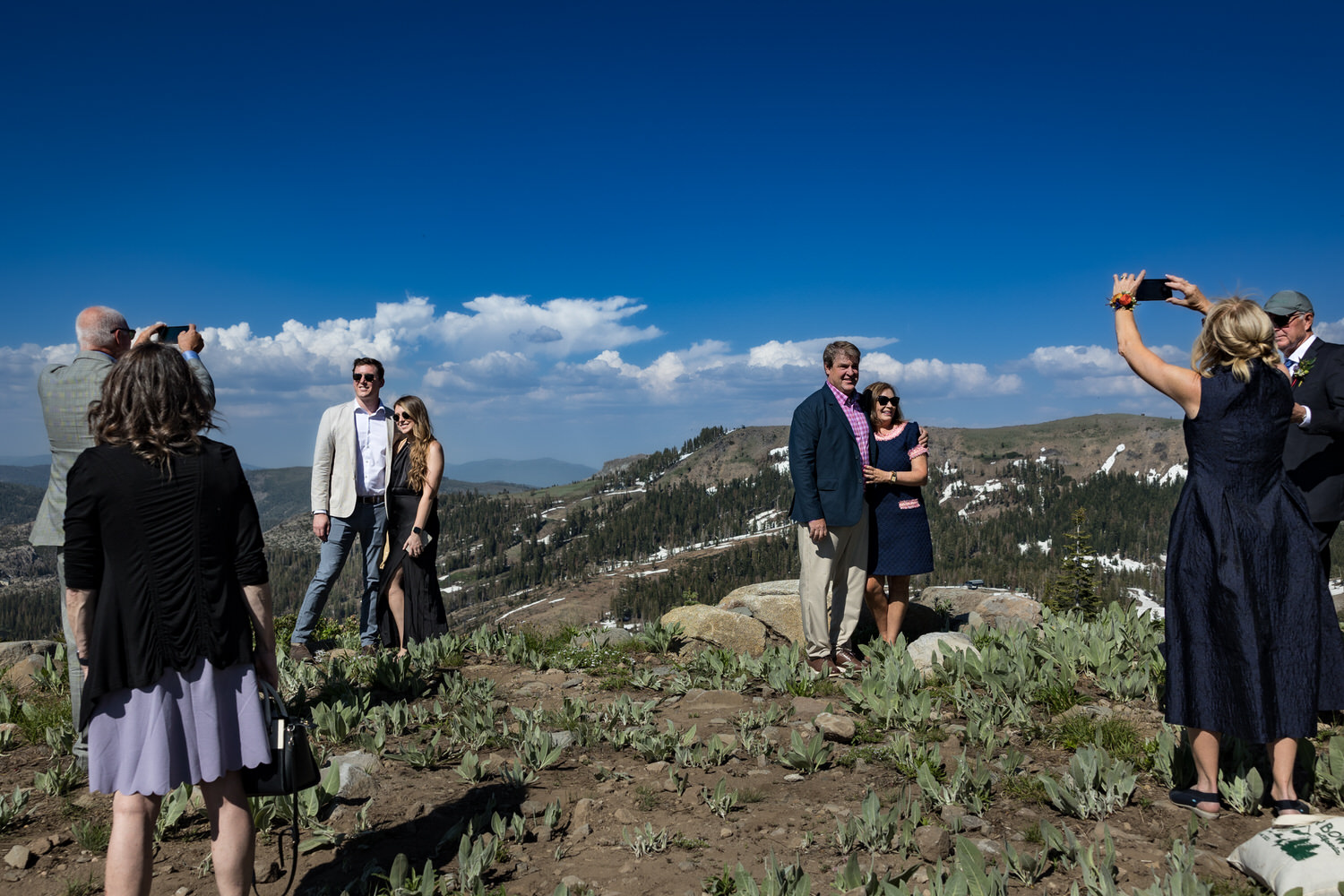 Wedding guests enjoy views of Donner Lake, Van Norden Meadow, and the surrounding landscape during a cocktail hour on Mt. Disney.